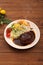 Hamburger steak with demi-glace sauce served on a plate