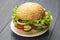 Hamburger with vegetables and sausage. Fast food and breakfast. Calories and diet