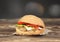 Hamburger on wooden table closeup.Burger on dark background