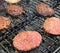 Hamburgers cooking on an outdoor grill