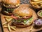 Hamburgers and French fries on the wooden tray