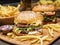 Hamburgers and French fries on the wooden tray