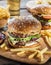 Hamburgers and French fries on the wooden tray