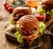 Hamburgers, homemade burgers with grilled buns with addition of addition of beef cutlet, lettuce, tomato,pickled cucumber, grille