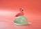 Hami melon flavor ice cream ball starts melting with a flamingo on top on a pink background