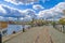 Hammarby canal embankments with moored vintage boats, promenade and waterfront apartment buildings at sunny spring day. Stockholm