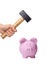 Hammer above a pink piggy bank