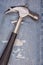 Hammer black handle tool with torn blue jeans pattern background