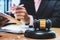 Hammer.Businessman sitting office,signing Signature contract papers on wood table.