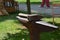 A hammer laying on an anvil in the park at sunny day