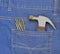 Hammer and nails in blue jeans pocket