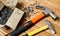 Hammer and nails scattered on wooden background. Joinery concept