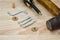 Hammer, screwdriver and fasteners on wooden table. tools and parts for assembling cabinet furniture