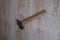 Hammer tool on blurred wooden background.