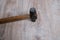 Hammer tool on blurred wooden background.