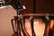 Hammered copper timpani with music stand on stage, horizontal