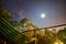 Hammock at night with fullmoon and stars in front of a mountain in the town of Phong Nha in the National Park of Phong