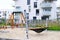 Hammock and swing on a children playground in cozy courtyard of modern residential district