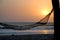 Hammock under a palm tree at sunset. Cap Skirring, Senegal