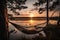 hammock with view of the sunset over a calm lake