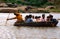 Hampi, India: People crossing the river in a crowded old style rowboat