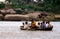 Hampi, India: People crossing the river in a crowded old style rowboat