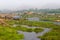 Hampi village Tungabhadra river meadow. Landscape with water, palm, rock, stones. India, Karnataka