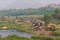 Hampi village Tungabhadra river meadow. Landscape with water, palm, rock, stones. India, Karnataka