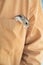 Hamster climbs out of brown pocket.