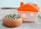 Hamster food in pottery and little home on wooden board