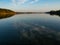 Hancza Lake, the deepest lake of the Poland. Sunny day, late afternoon, sky reflecting in the water.