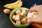 Hand Adding Diced Multigrain Bread into the Mixture for Baking Banana Bread Pudding