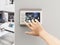 Hand adjusting room temperature using a digital thermostat screen. 3D illustration