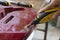 Hand of  adult artisan fixing old classic guitar adding cord and tuning the instrument. Close up of hands and pal