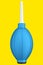 Hand air blower bulb for camera isolated on yellow background.