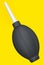 Hand air blower bulb for camera isolated on yellow background.