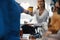 Hand of airline hostess passing coffee to customer