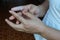 Hand applying medicinal cream on infectious fingers