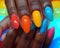 Hand applying vibrant nail polish