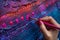 Hand applying vibrant paint dots to a textured canvas, suitable for art class visuals.