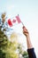 Hand arm waving holding canadian flag closeup