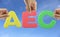 Hand arrange alphabet AEC of acronym ASEAN Economic Community.