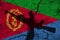 Hand assault rifle on the background of the flag of Eritrea and cracks. Eritrea Power Concept