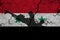 Hand assault rifle on the background  flag of Syria and cracks. Syria Power Concept