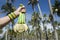 Hand of Athlete Holding Gold Medals Palm Trees