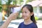 Hand of authorities with electronic infrared thermometer measuring asian little kid girl head before entering the playground