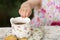 Hand of baby girl with porcelain tea cup