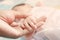 Hand baby hand mother closeup concept love family