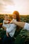 Hand of baby touches of the hand of father on a sunflower field