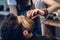 Hand of a barber using scissors while trimming